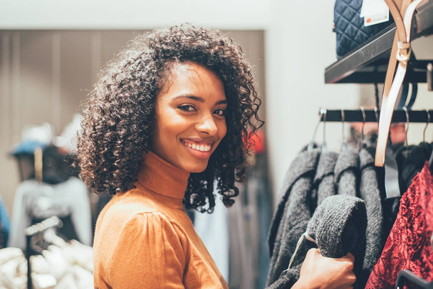 Black young woman doing shopping in a store - Photo, Image