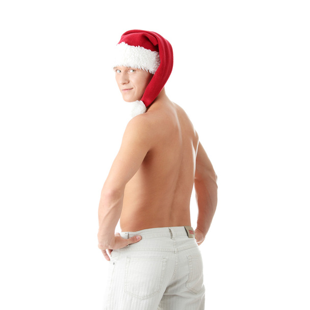Sexy muscular man wearing a Santa Claus hat - Foto, immagini