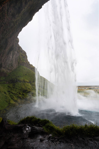 wet path in cave of Seljalandsfoss waterfall - Photo, Image