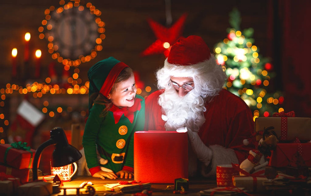 Santa Claus and little elf with magic gift for Christmas - Photo, Image