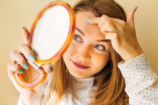 Shocked Woman Looking At Pimple On Forehead In Mirror. - Photo, Image
