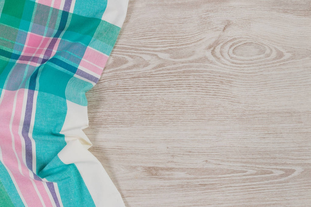 Cloth napkin on wooden background.  - Фото, зображення