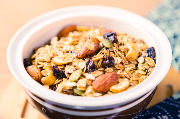 closed up of multi-grain cereal with dried fruits and nuts in an - Фото, зображення