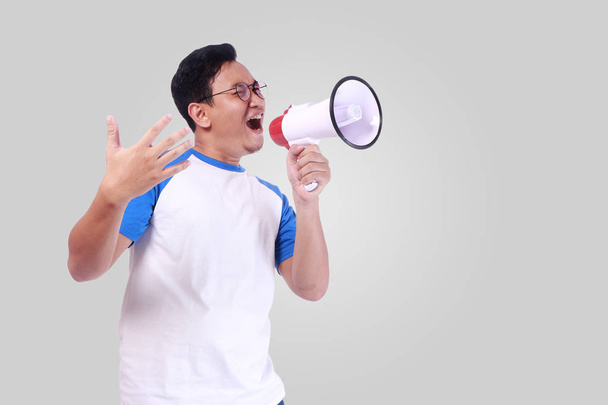Young Man Shouting with Megaphone, Promotion Concept - Photo, image