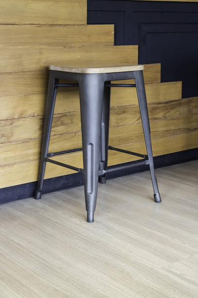 Wood and black metal bar chair on wall background - Foto, immagini