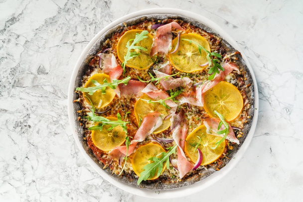 fresh delicious pizza with persimmon, close up - Foto, immagini
