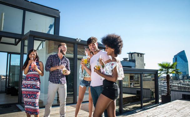 Friends partying on a rooftop - Fotoğraf, Görsel