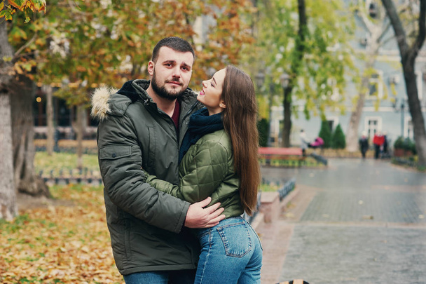 Young loving couple on a city street . Romantic couple in autumn city walk - Photo, Image
