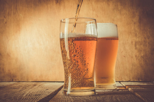 Beer in frosty mugs on rustic background - Photo, Image