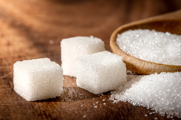 Close up  sugar cubes and cane in wooden spoon on the table ,ret - Fotografie, Obrázek