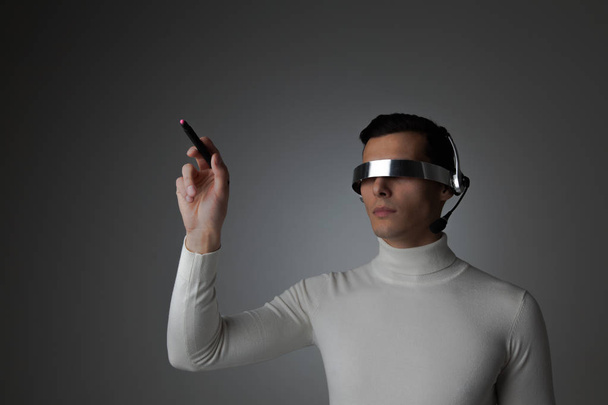 Man using futuristic VR goggles - Photo, image