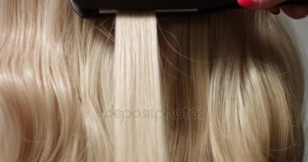 Styling blond vlasy se žehlička na vlasy - Záběry, video