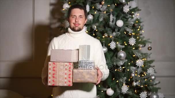 Handsome man is holding presents for his family - Metraje, vídeo