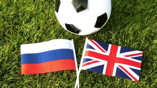 Fotbalový míč a vlajky Ruska a Velké Británie. Fotbalový míč v trávě, světový pohár. - Záběry, video