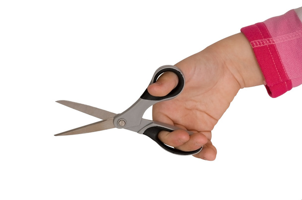Child hand holding open scissors - Photo, Image