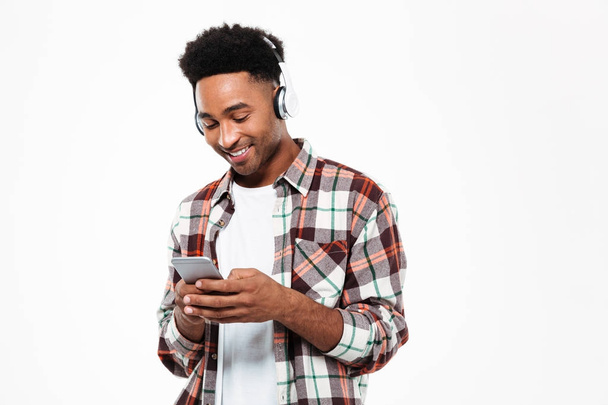 Portrait of a cheerful young afro american man in headphones - Fotografie, Obrázek
