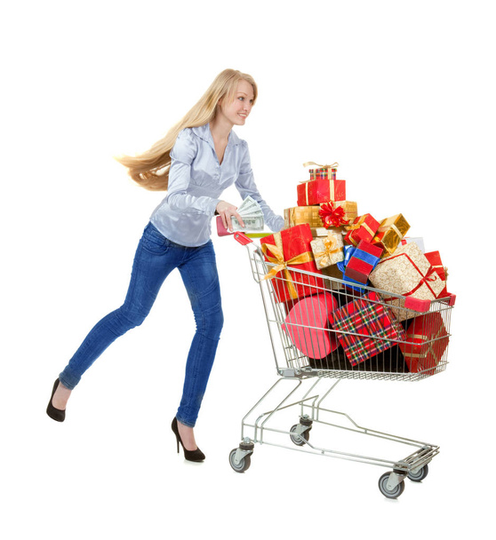 Young Beautiful Woman Running with Shopping Cart of Christmas Pr - Foto, afbeelding