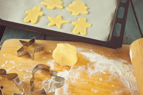 Unbaked cookies and cookie cutter forms on the table - Photo, Image