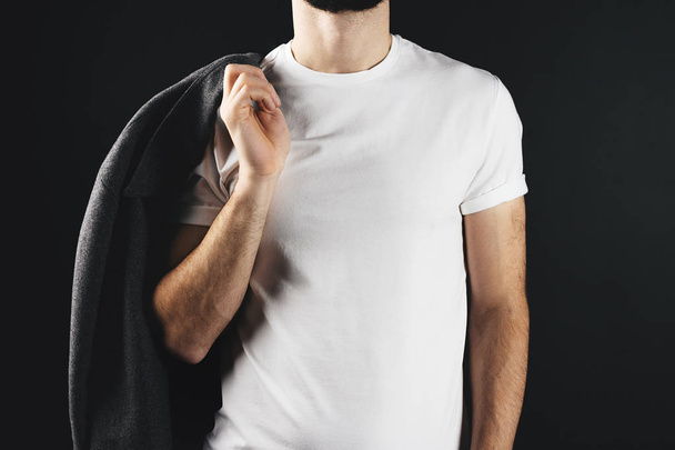 Strong man close-up with coat on his shoulder wearing white blank t-shirt - Photo, image