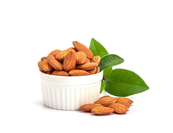 the fresh almonds in white cup on white background - Photo, Image