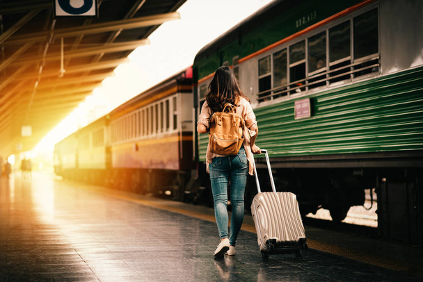 Mujer viajera turista caminando con equipaje en la estación de tren. Concepto de estilo de vida activo y viajes
 - Foto, imagen