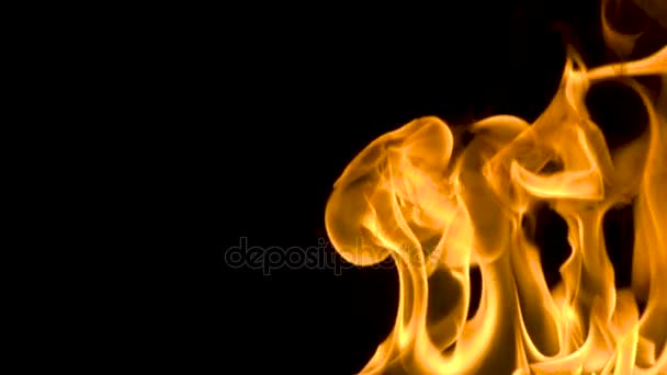 Fire and flames burning on a reflective glass surface, in slow motion with a black background, with the flames moving slowly - Footage, Video