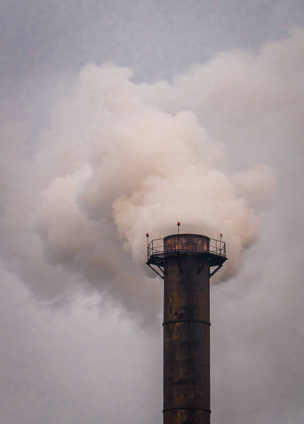 Trompete auf dem Hintergrund eines düsteren Himmels. Umweltverschmutzung - Foto, Bild