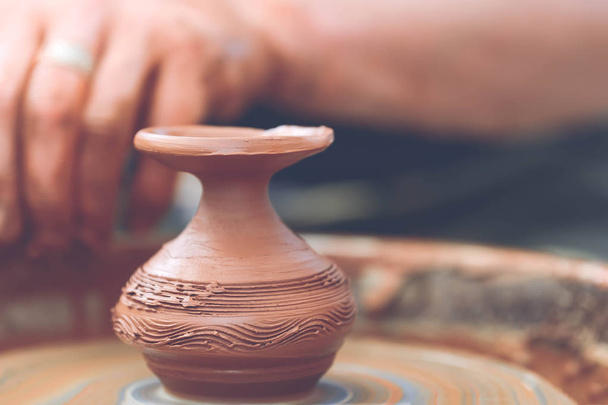 Potter making ceramic pot on the pottery wheel - Photo, Image