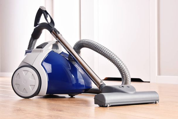 Canister vacuum cleaner for home use on the floor panels - Fotografie, Obrázek