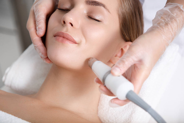 Calm young woman getting cavitation rejuvenation skin treatment - Zdjęcie, obraz
