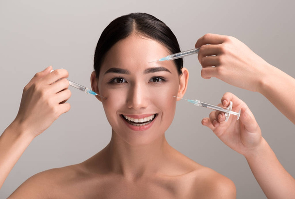 Young woman is enjoying plastic aesthetic facial surgery - Foto, imagen