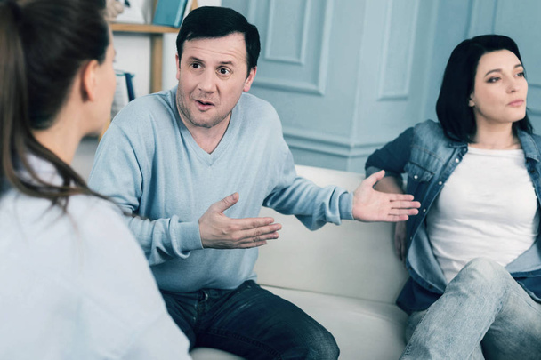 Confused emotional man talking with his psychologist - Photo, image