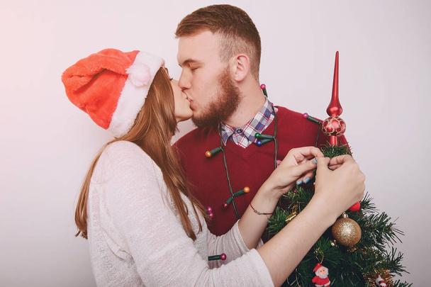 loving couple decorating Christmas tree - Photo, image