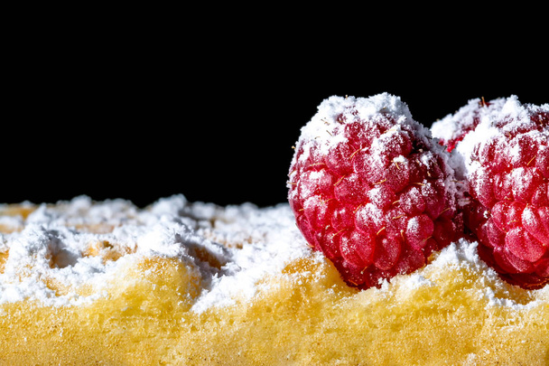 Sweet toast waffles with raspberries and sugar powder close-up macro on a black background - Foto, imagen