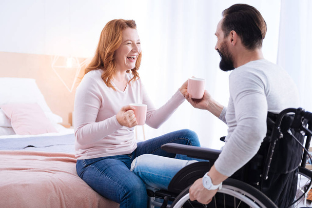 man and disabled woman laughing out loud - Фото, изображение