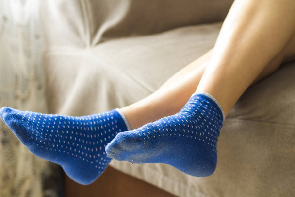Woman feet in blue socks.Relaxing and comfort holiday concept. - Photo, Image