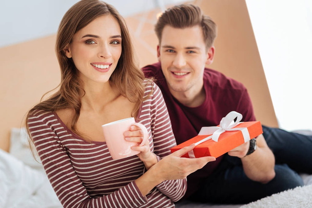 Happy young woman receiving gift from boyfriend - Photo, Image