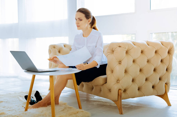 Tired hardworking woman sitting in front of a laptop - Фото, зображення