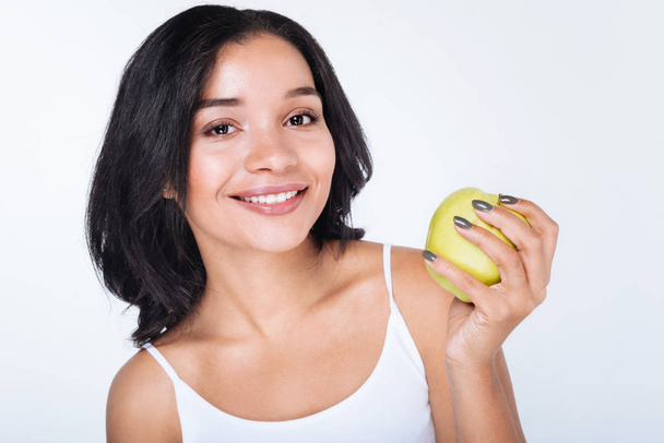 woman holding an apple - Фото, изображение