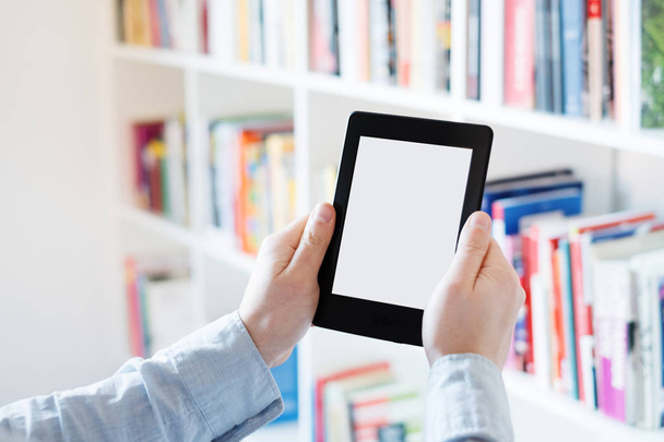 E-book reader in hands in a bookstore - Photo, Image