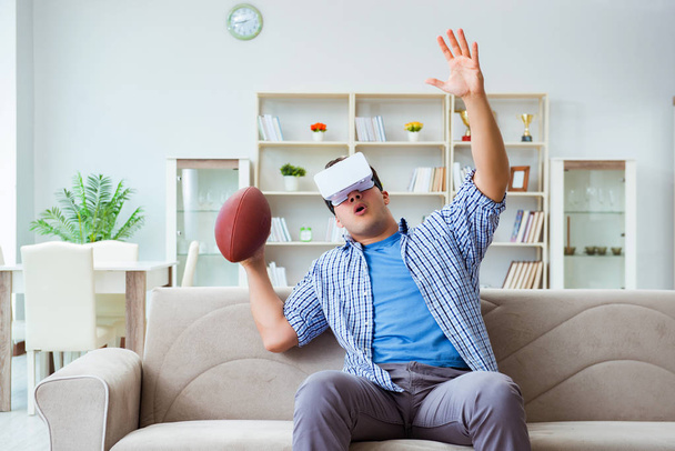 Man wearing virtual reality VR glasses watching american footbal - Foto, Bild
