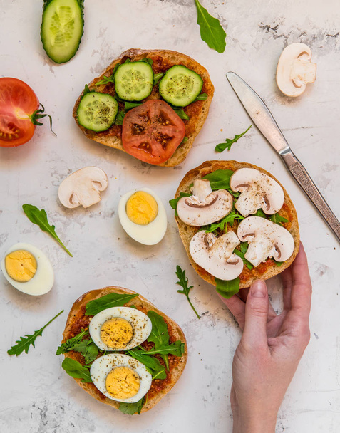 Sandwiches for breakfast. Ciabatta with arugula, egg, mushrooms, - Fotografie, Obrázek