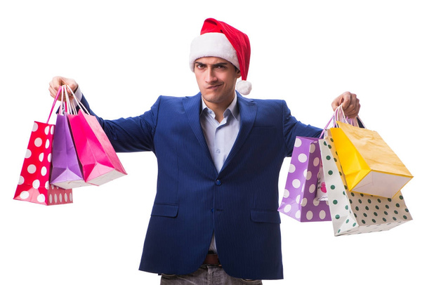 Νεαρός άνδρας με τσάντες μετά τα Χριστούγεννα ψώνια σε λευκό φόντο - Φωτογραφία, εικόνα