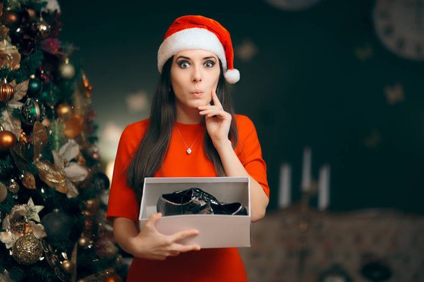 Cheerful Girl Receiving Silver Flat Shoes as Christmas Gift - Fotografie, Obrázek