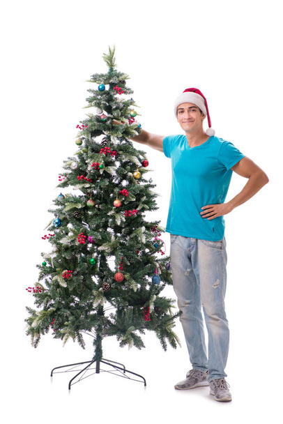 Junger Mann schmückt Weihnachtsbaum isoliert auf Weiß - Foto, Bild