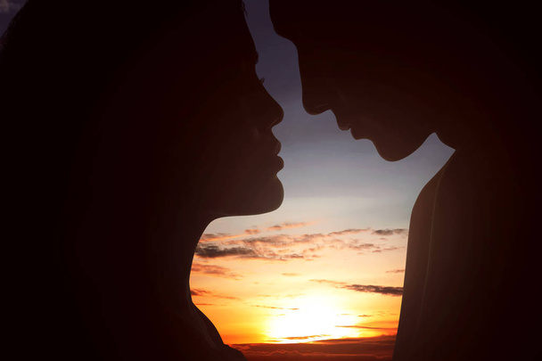 Romantic couple looking at each other on sunset background - Fotografie, Obrázek