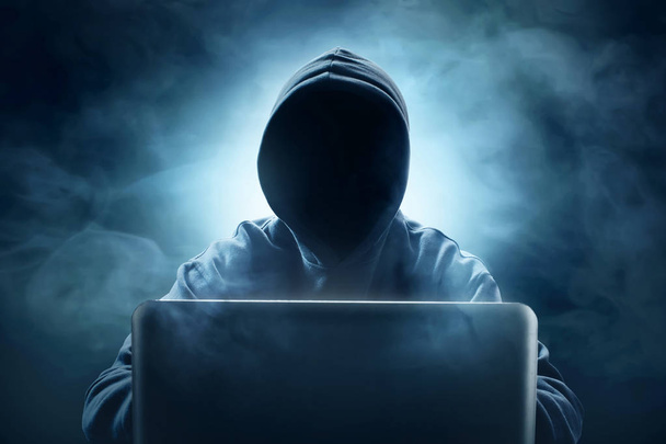 Unknown hacker using laptop - Photo, Image