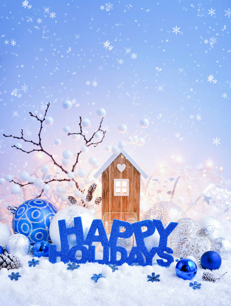 Greeting "Happy Holidays", decorative balls and toy house on a background of christmas lights - Φωτογραφία, εικόνα