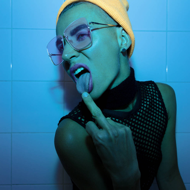 Aggressive Tomboy Girl in Fashion accessory glasses, beanie and  - Fotoğraf, Görsel