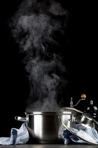 Steaming pot on black background - Photo, Image